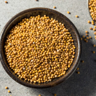 Raw Organic Yellow Mustard Seeds in a Bowl