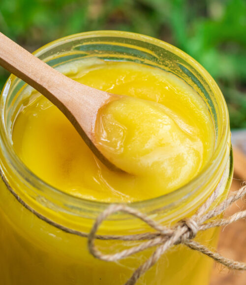 Ghee in a jar in a meadow. Selective focus. food.