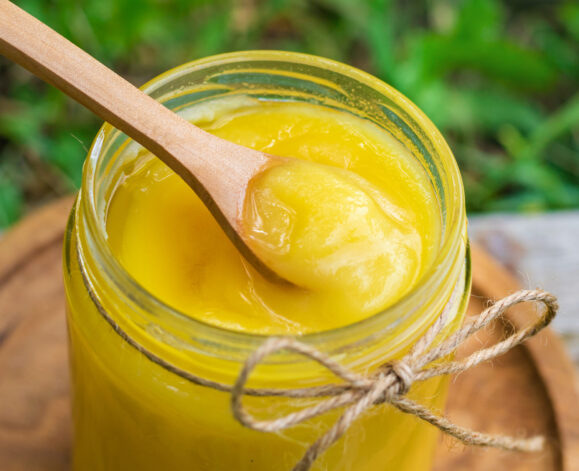 Ghee in a jar in a meadow. Selective focus. food.